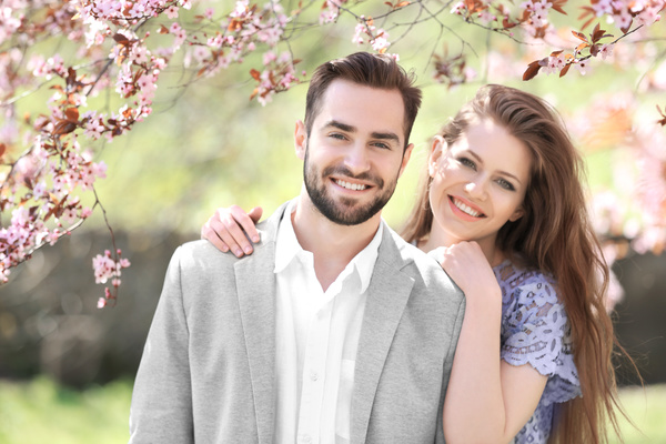 Young lovely couple walking in spring park - MASKULIN